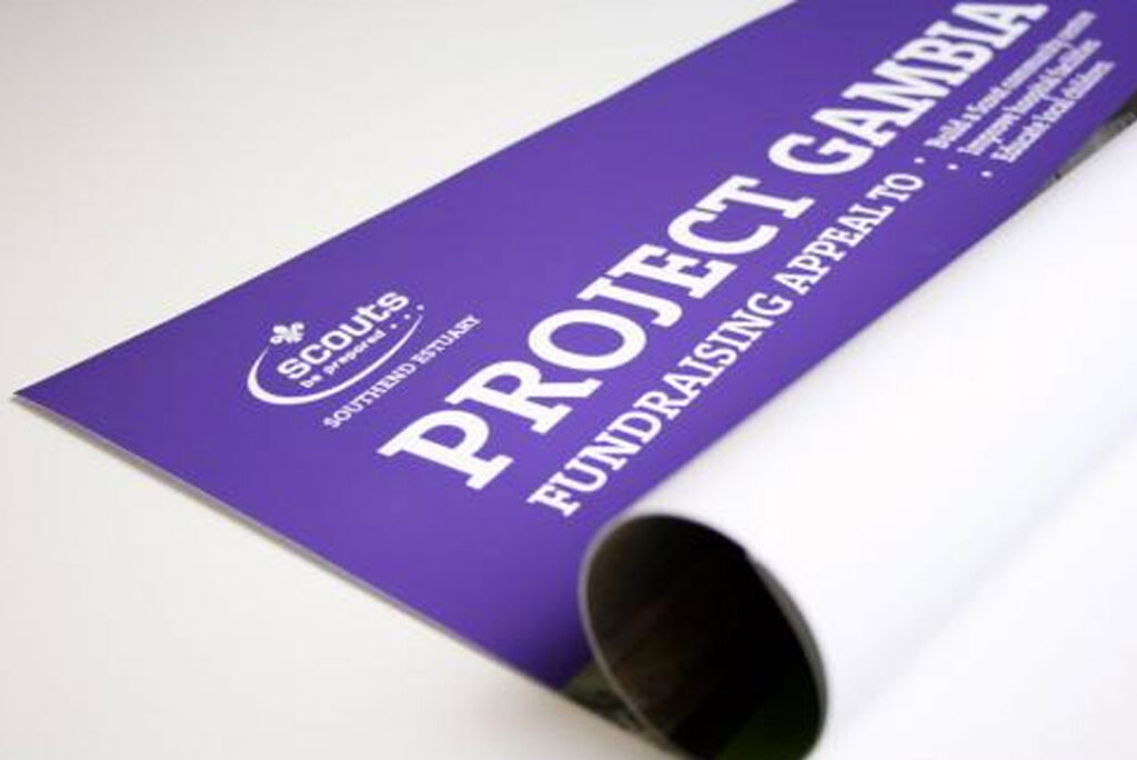 A purple poster half rolled up and half laid flat